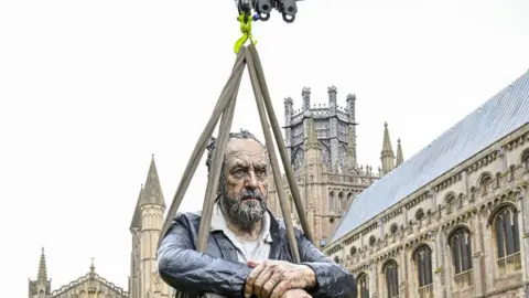 Ely Cathedral Sculpture of man being hoisted