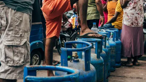 Getty Images Orang-orang mengantre untuk mendapatkan bensin di stasiun pengisian bahan bakar Pelawatte Litro Gas di Kolombo, Sri Lanka, pada Minggu, 22 Mei 2022. S