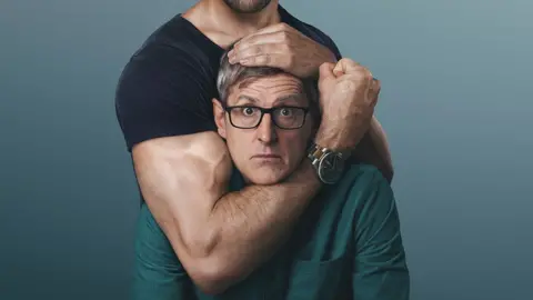 A promotional image taken in a studio shows Louis Theroux looking nervously into the camera as an anonymous man with a muscular frame pretends to hold him in a headlock. The man's bent elbow cradles Theroux's head as his bulging bicep pressing against the film-maker's ear.