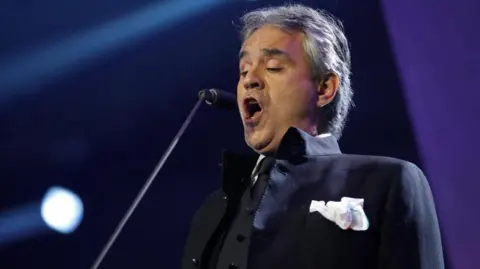 Andrea Bocelli singing on stage 