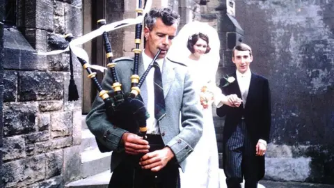 Campbell family Alasdair Eòsaph is piping as he leads newly weds from a church.