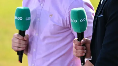 Two men holding GAAGO microphones