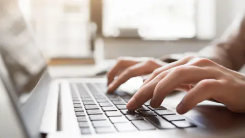 Hands touching a keyboard