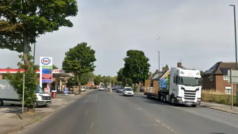 A view of the street with a petrol station by the roadside