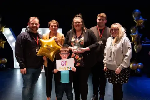 Josie Eddy Josie with her family when she won the volunteer of the year award