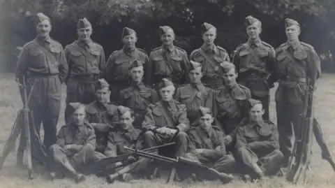 No. 2 Section Osney Platoon 1941 some sat and some stood for a photograph with riffles