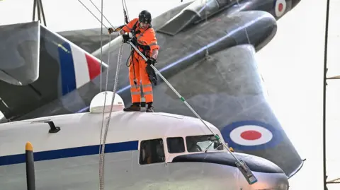 RAF Museum Man cleaning an aircraft