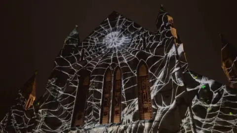 Spiders web decoration projected onto side of church