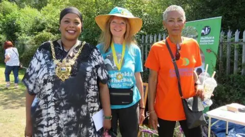 Des Smith Mayor Safiya Saeed stood next to representatives from the Sheffield Caribbean Sports Club and Sheffield and Rotherham Wildlife Trust.