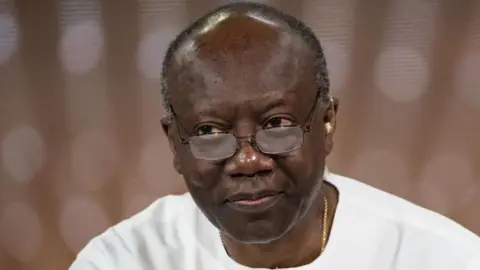A close-up of Ken Ofori-Atta wearing glasses 