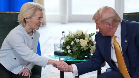 Getty Images European Commission President Ursula von der Leyen shakes hands with US President Donald Trump during a meeting at Trump Turnberry golf club in Scotland on 27 July 2025