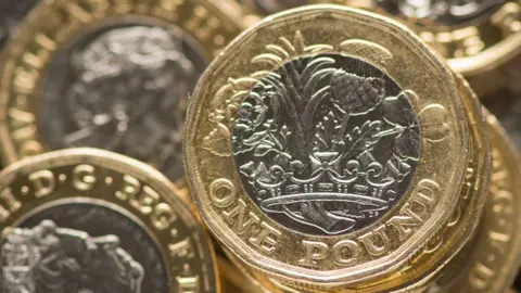 PA Media One pound coins in stacks viewed from above