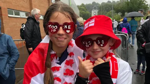 Emma Barnard/BBC Isla and Izzy outside Carrow Road