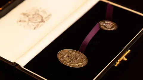 PA Media A picture of the awards with the inscription: "For a life given in service."