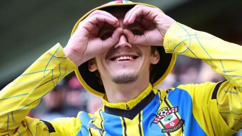 Getty Images A Southampton fan gestures prior to the play off semi-final second leg match between Middlesbrough and Southampton at Riverside Stadium. 