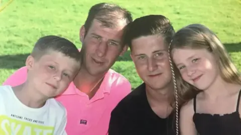 Family photo Scott Hendy and his family smiling at the camera