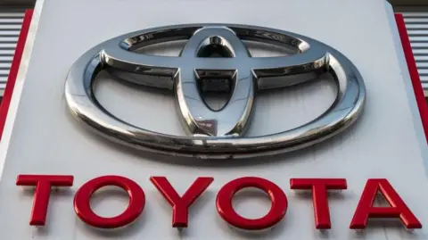 A sign for Japan's Toyota Motor is displayed at a dealership in Tokyo.