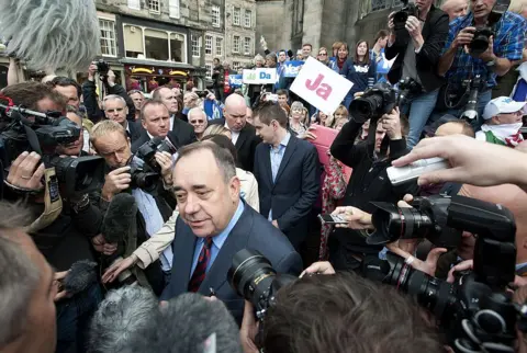 Getty Images Salmond in Parliament Square, Edinburgh, surrounded by journalists and pro-independence campaigners carrying 