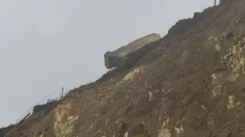 A large slab of concrete overhanging a cliff