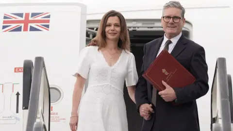 PA Media Keir Starmer and his wife Victoria board a plane at Stansted Airport in Essex as they head to Washington DC to attend a Nato summit