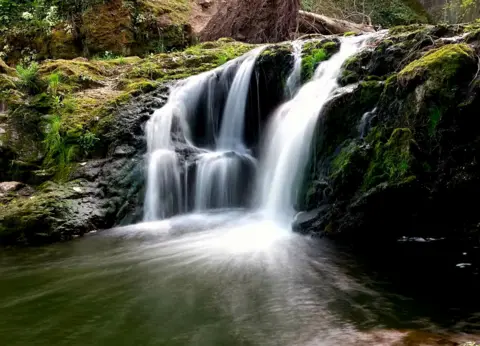 Andrew Smart A photo of a waterfall taken on a long exposure 
