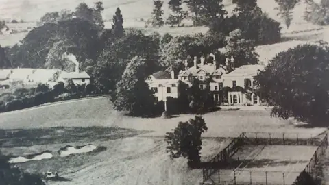 The Mitchell family A black and white photograph of the clubhouse, tennis courts and The Walled Garden 