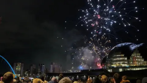 NE1 Fireworks behind The Glasshouse in Gateshead on the Quayside. They light up the night sky.
