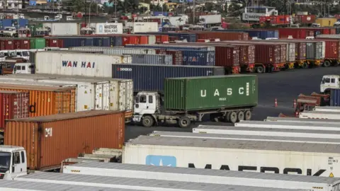 Bloomberg via Getty Images Shipping containers sit on trucks at the Jawaharlal Nehru Port in Navi Mumbai, Maharashtra, India,