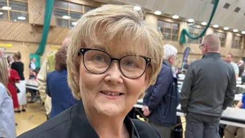Tracey Dixon during the vote count. She has blonde hair and wears dark-rimmed glasses.