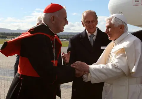 Getty Images Pope Benedict XVI being greeted by Prince Philip, Duke of Edinburgh and Cardinal Keith O'Brien when he arrived at Edinburgh Airport at the start of a four-day visit to Britain in 2010