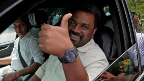 Sri Lanka's President and National People's Power (NPP) party leader Anura Kumara Dissanayake gestures as he leaves after casting his vote on the day the parliamentary election in Colombo, Sri Lanka, November 14, 2024.