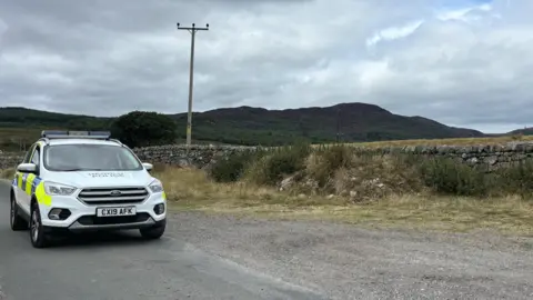 A police car close to the crash scene