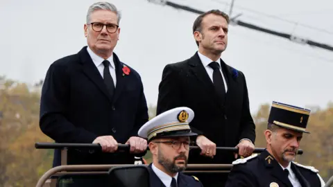 Reuters France's President Emmanuel Macron and Britain's Prime Minister Keir Starmer arrive at Place de l'Etoile to attend commemorations marking the 106th anniversary of the 1918 Armistice