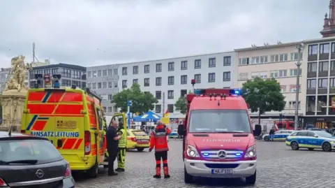 DPA via AP Ambulance and paramedics inside Mannheim market square