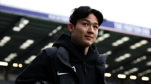 Yang Min-hyeok walking along side of pitch at Fratton Park head shot