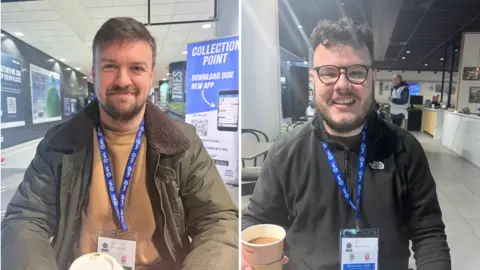 Creator of the Sky Blues documentary Jamie McGough on the left smiling into the camera wearing a green jacket and brown jumper wearing a lanyard. The second creator of the documentary Keiran Doherty on the right smiling at the camera wearing black glasses, and a black North Face fleece, with a lanyard, holding a coffee.
