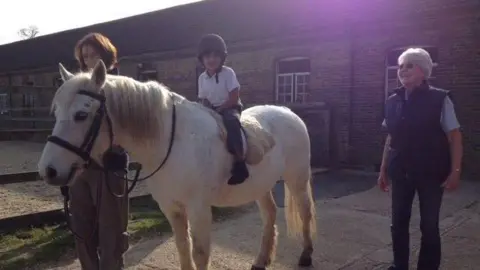 Kavitha Govind as a young boy on a horse.