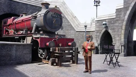 Getty Images A red Hogwarts Express train is seen in "Wizarding World of Harry Potter" theme park at Universal Studios Hollywood