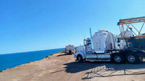 Michael Webb A truck parked on a cliff top overlooking the ocean