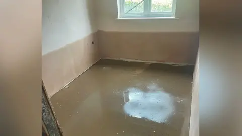 Liam Reilly A room with a window that shows water damage