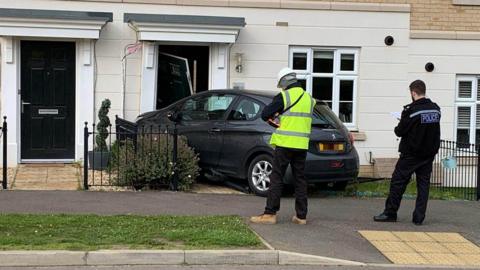 The scene of the collision involving a car that crashed into a house