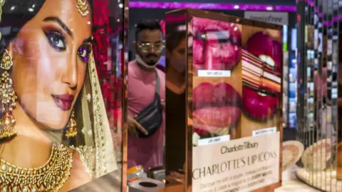 An advertisement for Charlotte Tilbury with a model dressed as an Indian bride at a Nykaa beauty store in New Delhi, India. 