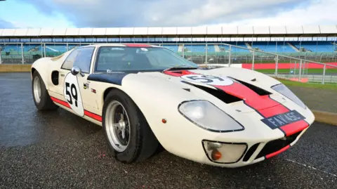 A white and red Ford GT40 in racing livery.