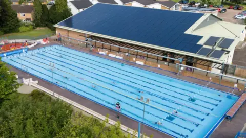 People swim at Banbury Lido at Woodgreen Leisure Centre in Oxfordshire.
