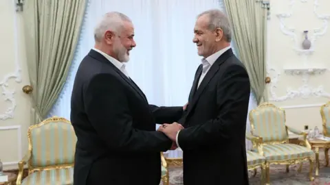 Getty Images Ismail Haniyeh (L), the political leader of Hamas, attends a meeting with Iranian President Masoud Pezeshkian, on July 30, 2024 in Tehran, Iran. Ismail Haniyeh, the political leader of Hamas who lived in Qatar, was visiting Tehran this week for the new Iranian president's inauguration.