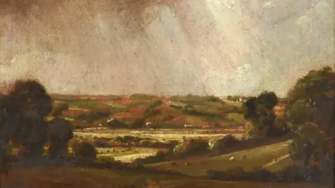 Tennants Auctioneers Dedham Vale looking towards Langham, is a sketch of a landscape from a distance the colours dark brown and green. Some red in the hills in the distance, there is light coming down through the clouds at the top of the picture. 