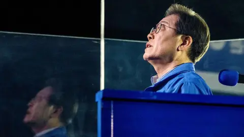 AFP via Getty Images Lee Jae-myung, the presidential candidate for South Korea's Democratic Party, sings the national anthem during his final election campaign event ahead of the upcoming June 3 presidential election in Seoul on June 2, 2025.