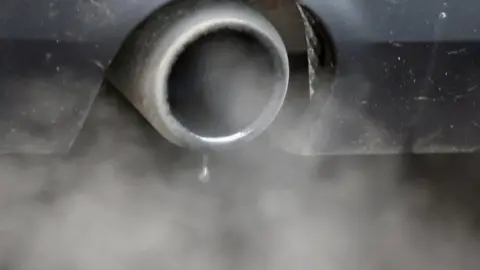 Reuters A close up image of fumes pouring out of the exhaust pipe of a vehicle