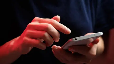 Getty Images Person on phone