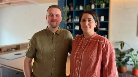 Picture of Will and Sogand Howard in their kitchen